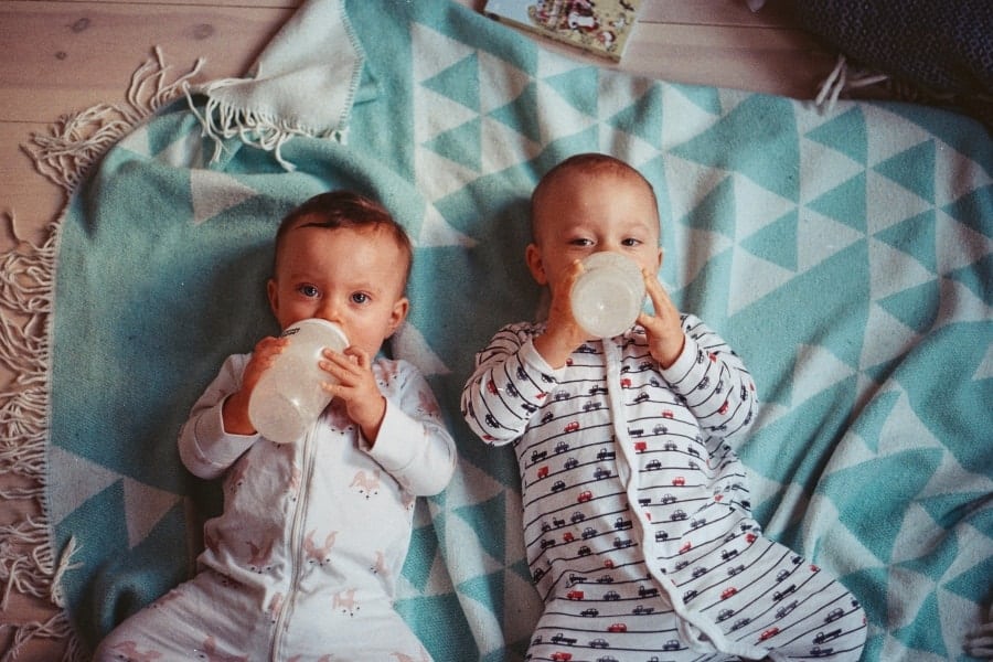 Babies drinking from baby bottles