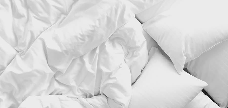 white bed sheets and pillows