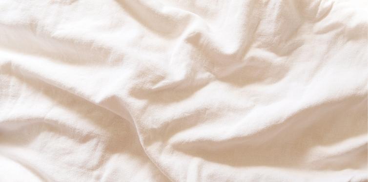 Wrinkled white bamboo bed sheets